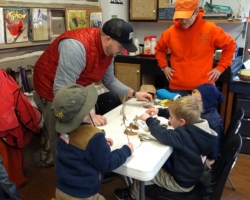 Linda Tonnies focuses on a fall nature collage made by Sacred Heart Villa students.